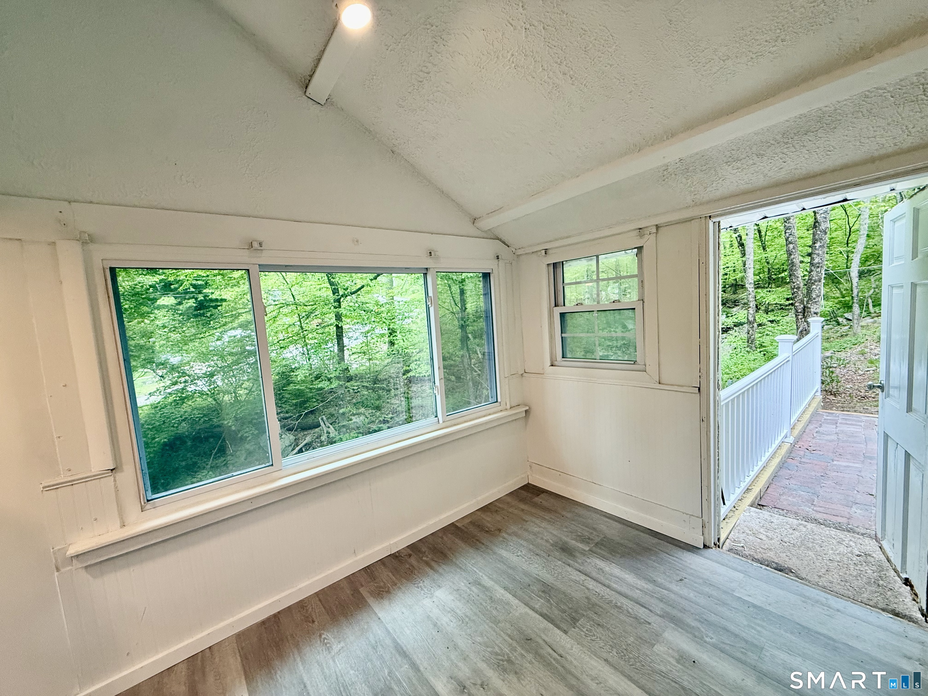 277 Lake Road Andover, CT 06232 - Photo 13 of 18 a view of an empty room with wooden floor and a window