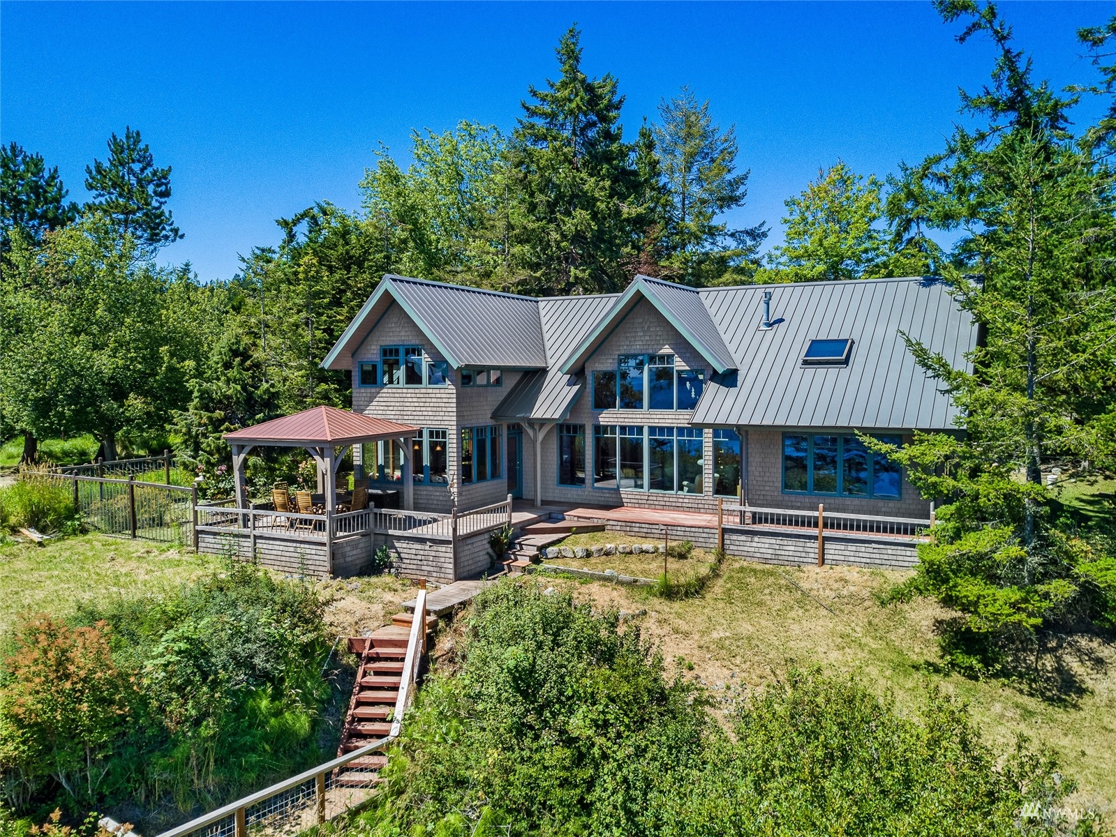 3209 Pear Point Road Friday Harbor, WA 98250 - Photo 22 of 40 a front view of a house with garden