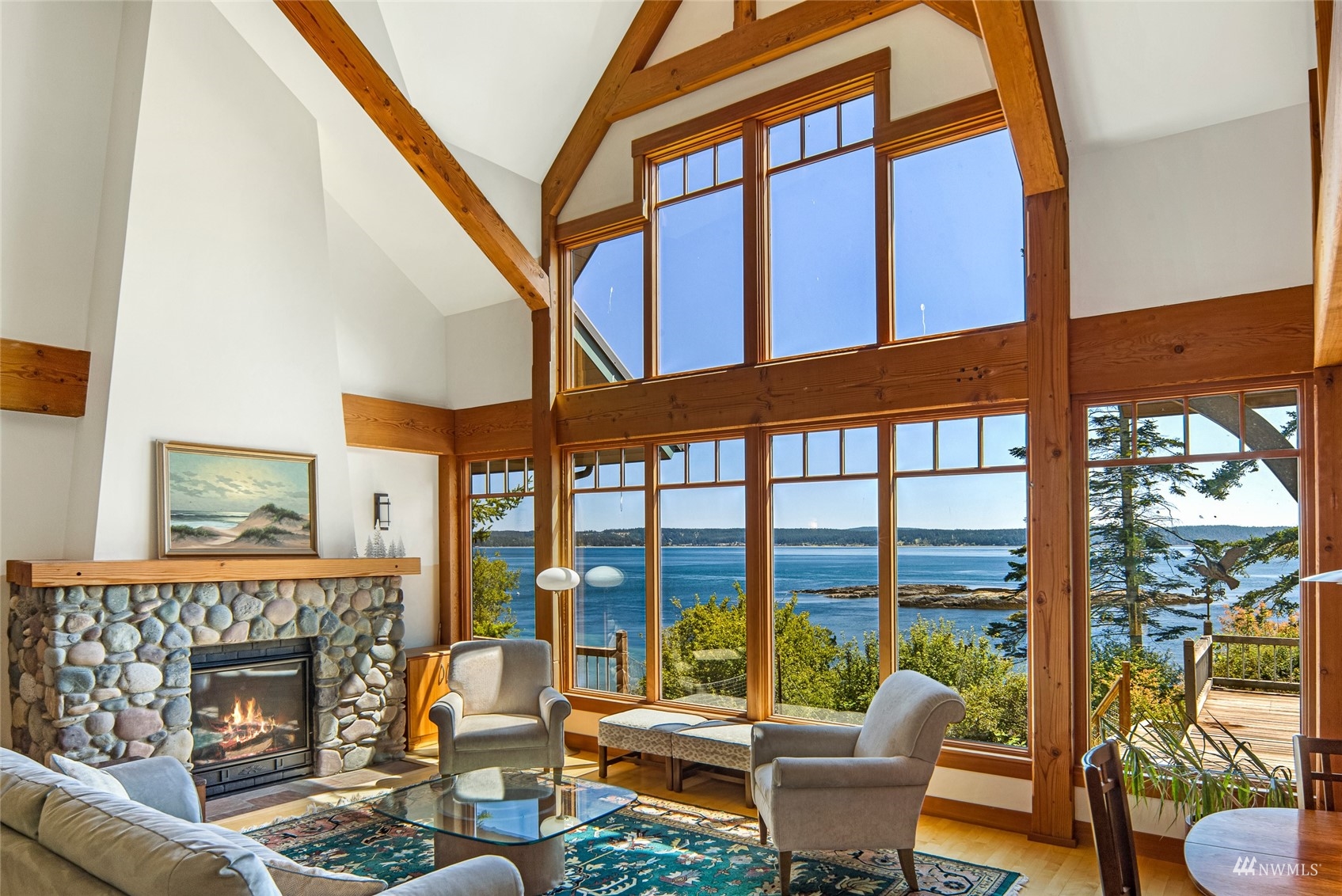 3209 Pear Point Road Friday Harbor, WA 98250 - Photo 6 of 40 a living room with furniture a fireplace and a floor to ceiling window