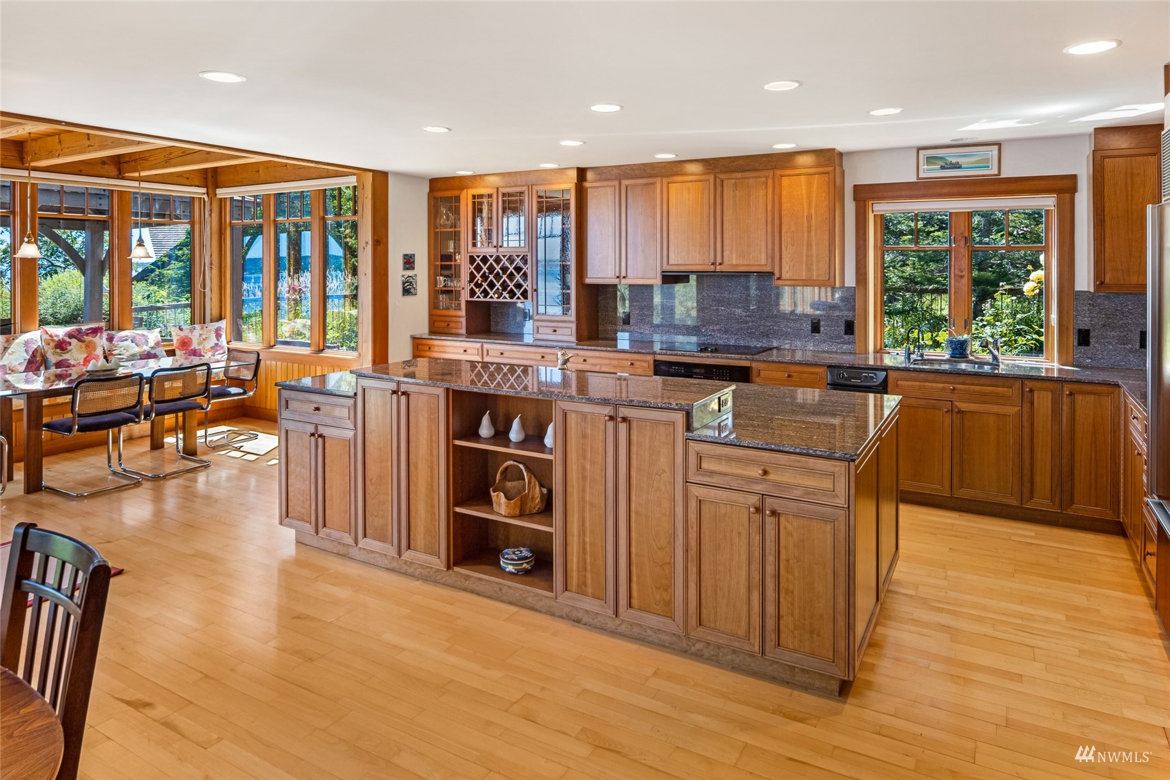 3209 Pear Point Road Friday Harbor, WA 98250 - Photo 10 of 40 a kitchen with stainless steel appliances granite countertop a stove a sink dishwasher and a microwave with wooden floor