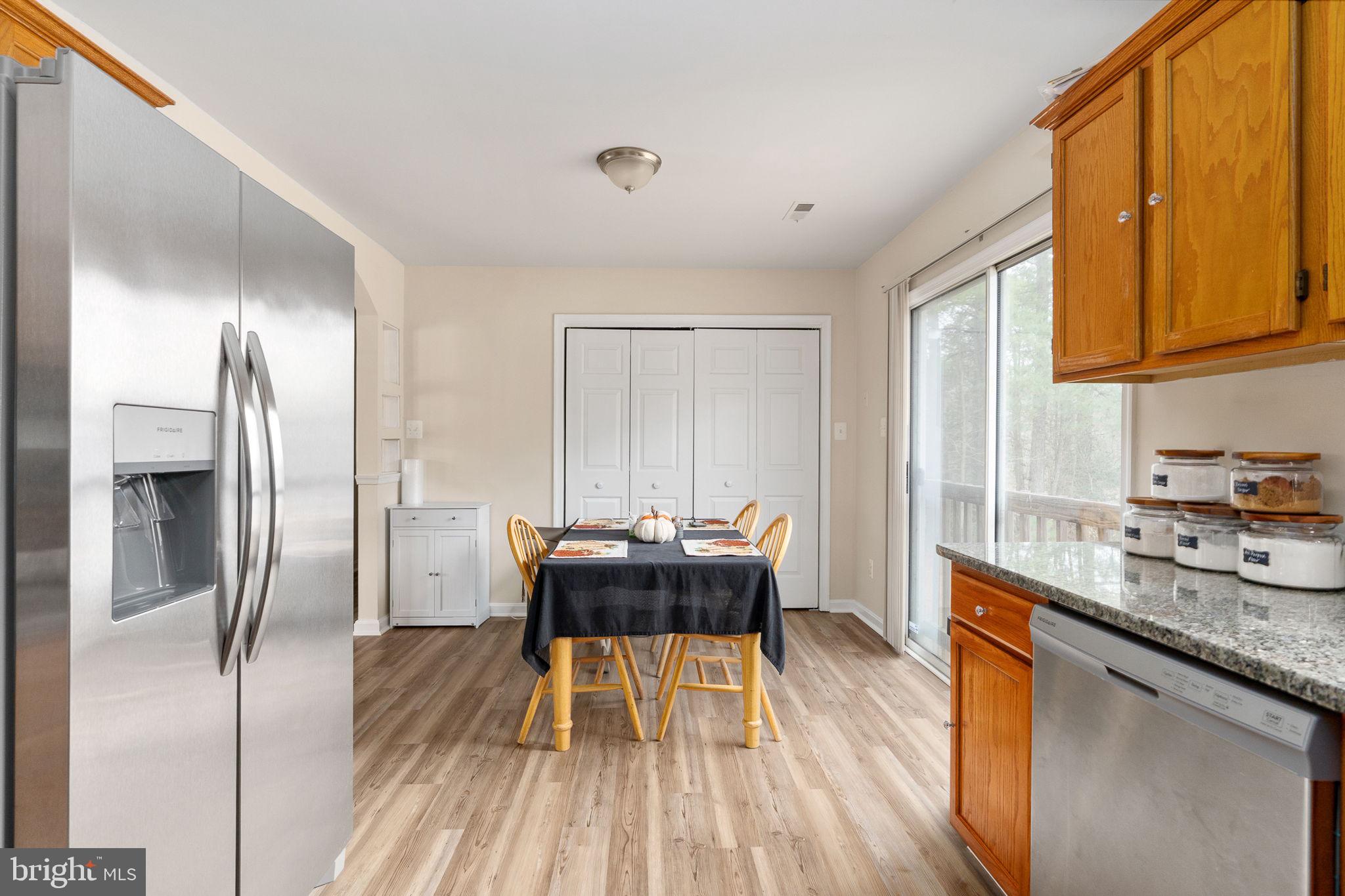 29315 Sparta Road Milford, VA 22514 - Photo 13 of 28 a kitchen with a table chairs refrigerator and window