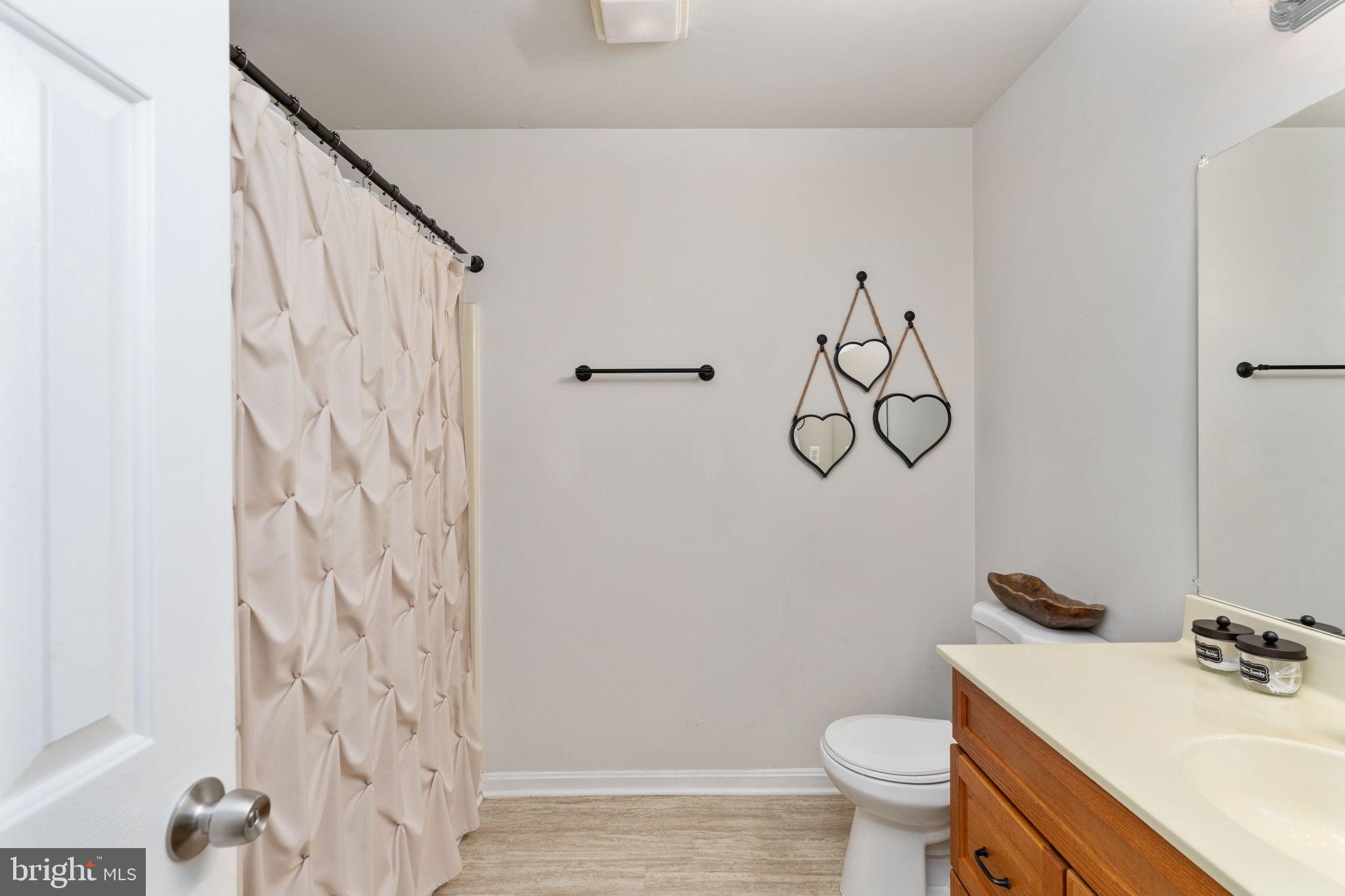 29315 Sparta Road Milford, VA 22514 - Photo 14 of 28 a bathroom with a granite countertop sink toilet and shower