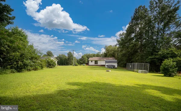 a view of a swimming pool with an outdoor seating and a yard