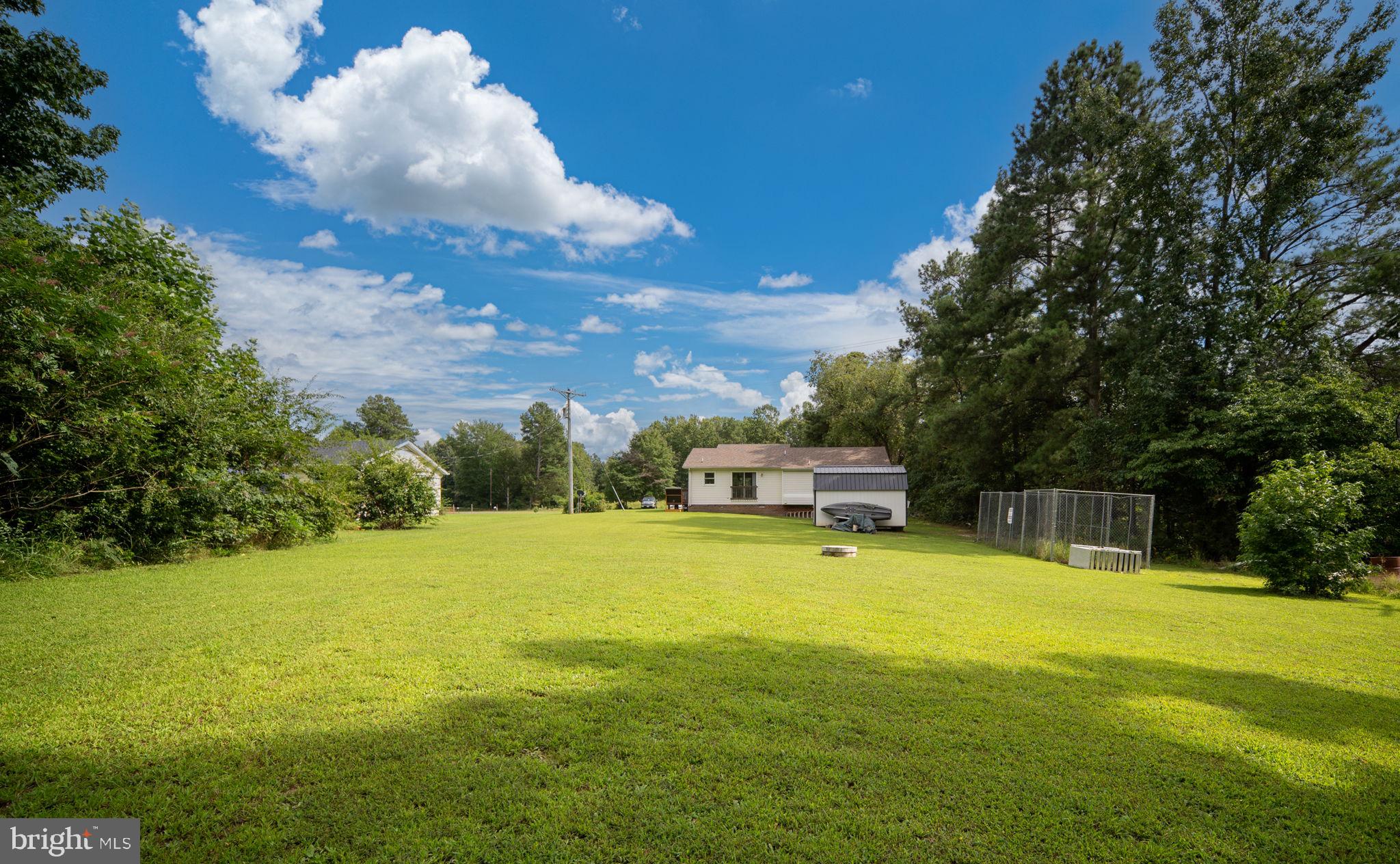29315 Sparta Road Milford, VA 22514 - Photo 23 of 28 a view of a swimming pool with an outdoor seating and a yard