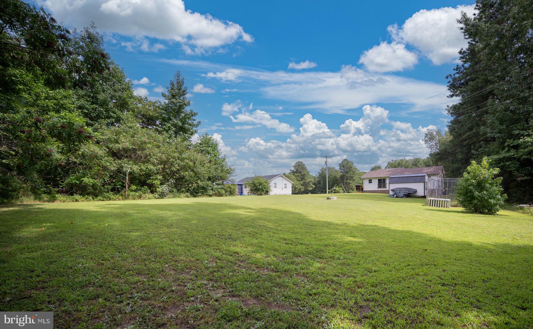 29315 Sparta Road Milford, VA 22514 - Photo 24 of 28 a view of a big yard with a house in the background