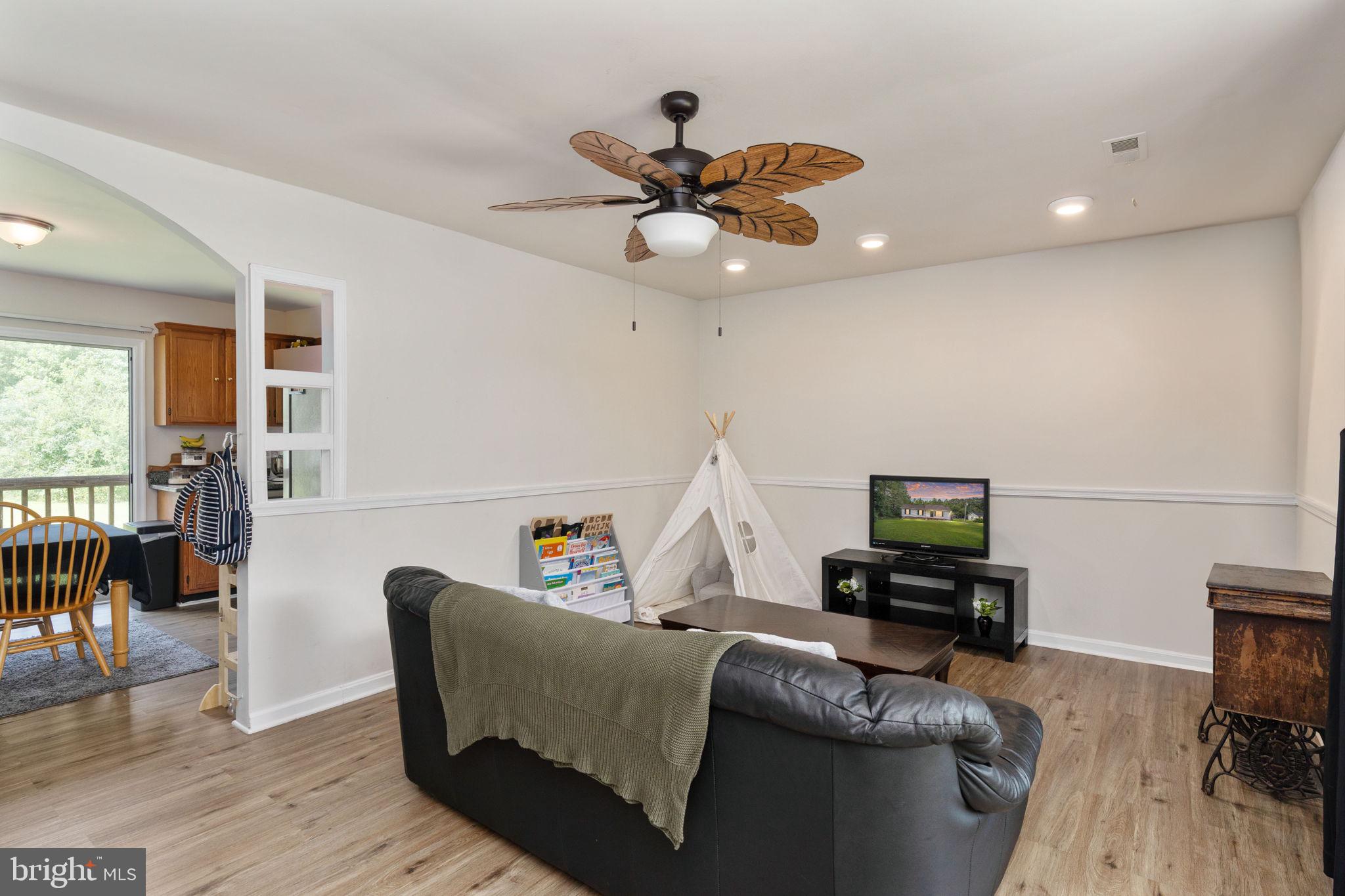 29315 Sparta Road Milford, VA 22514 - Photo 3 of 28 a living room with furniture and a wooden floor