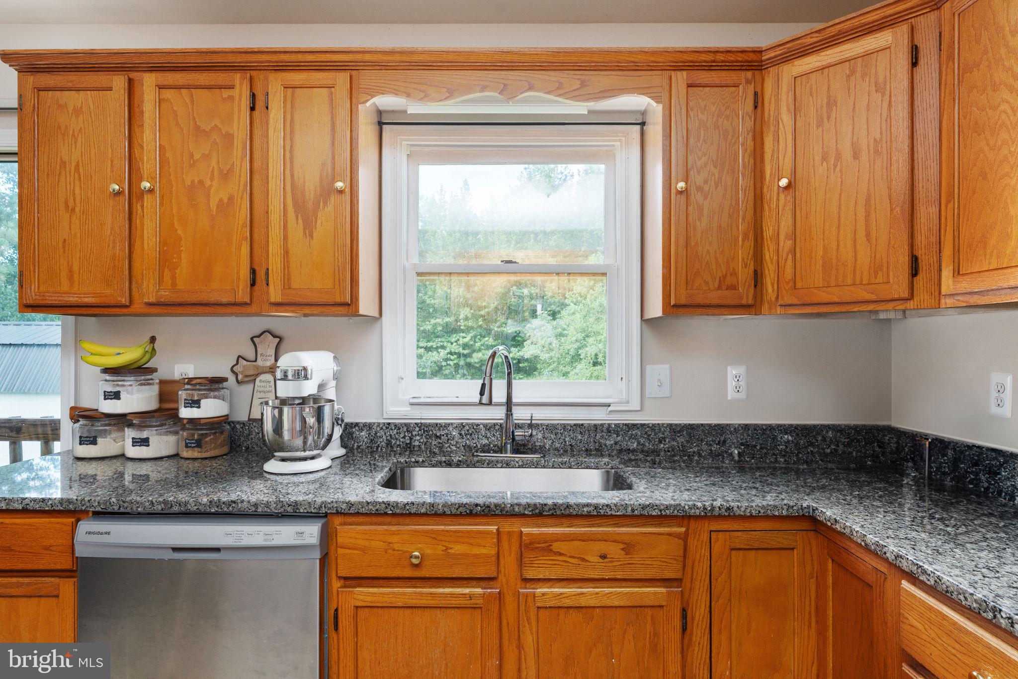 29315 Sparta Road Milford, VA 22514 - Photo 8 of 28 a kitchen with granite countertop stainless steel appliances a sink window and cabinets