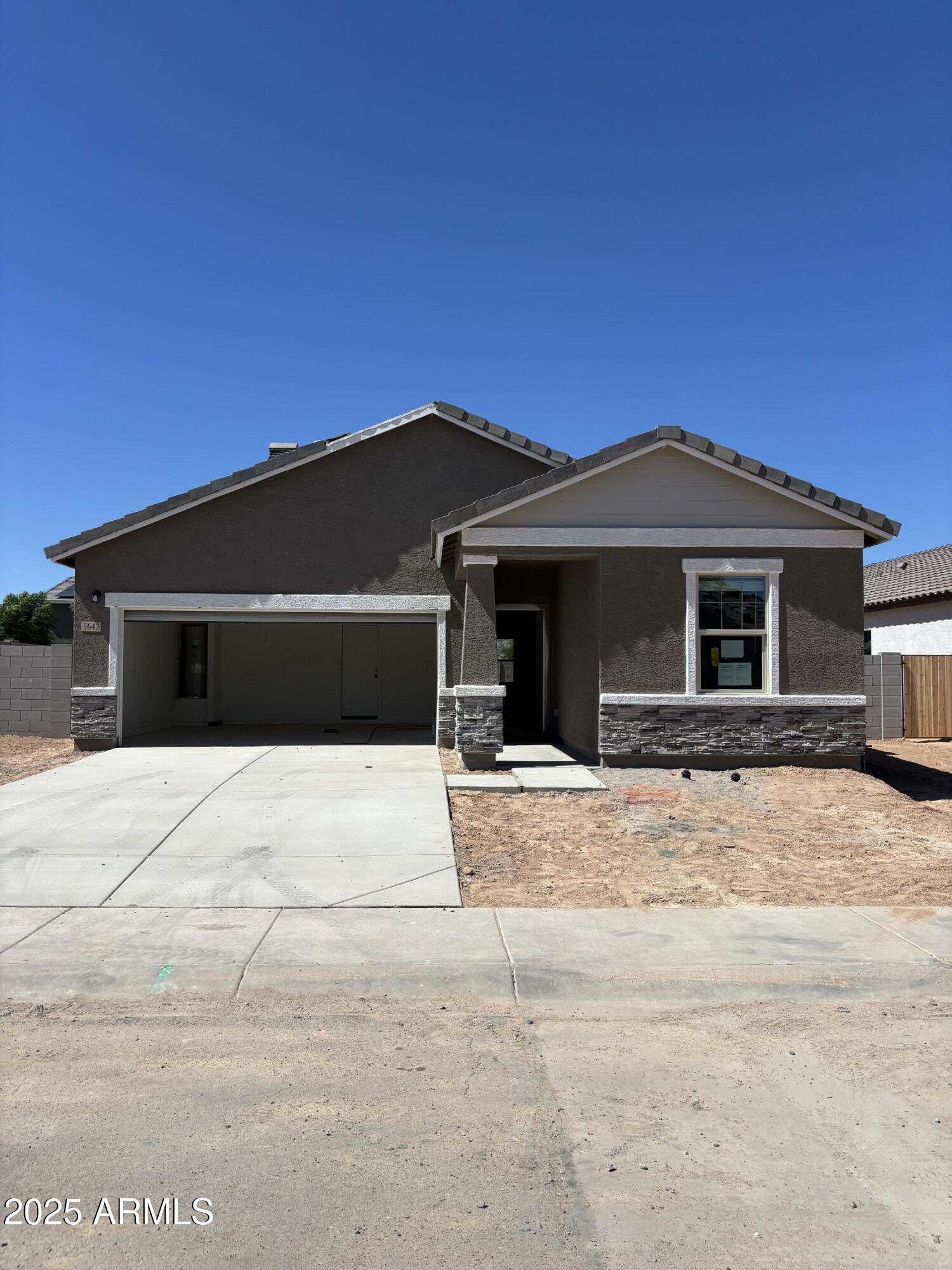 5642 East Iris Drive Florence, AZ 85132 - Photo 2 of 13 a front view of a house with a yard