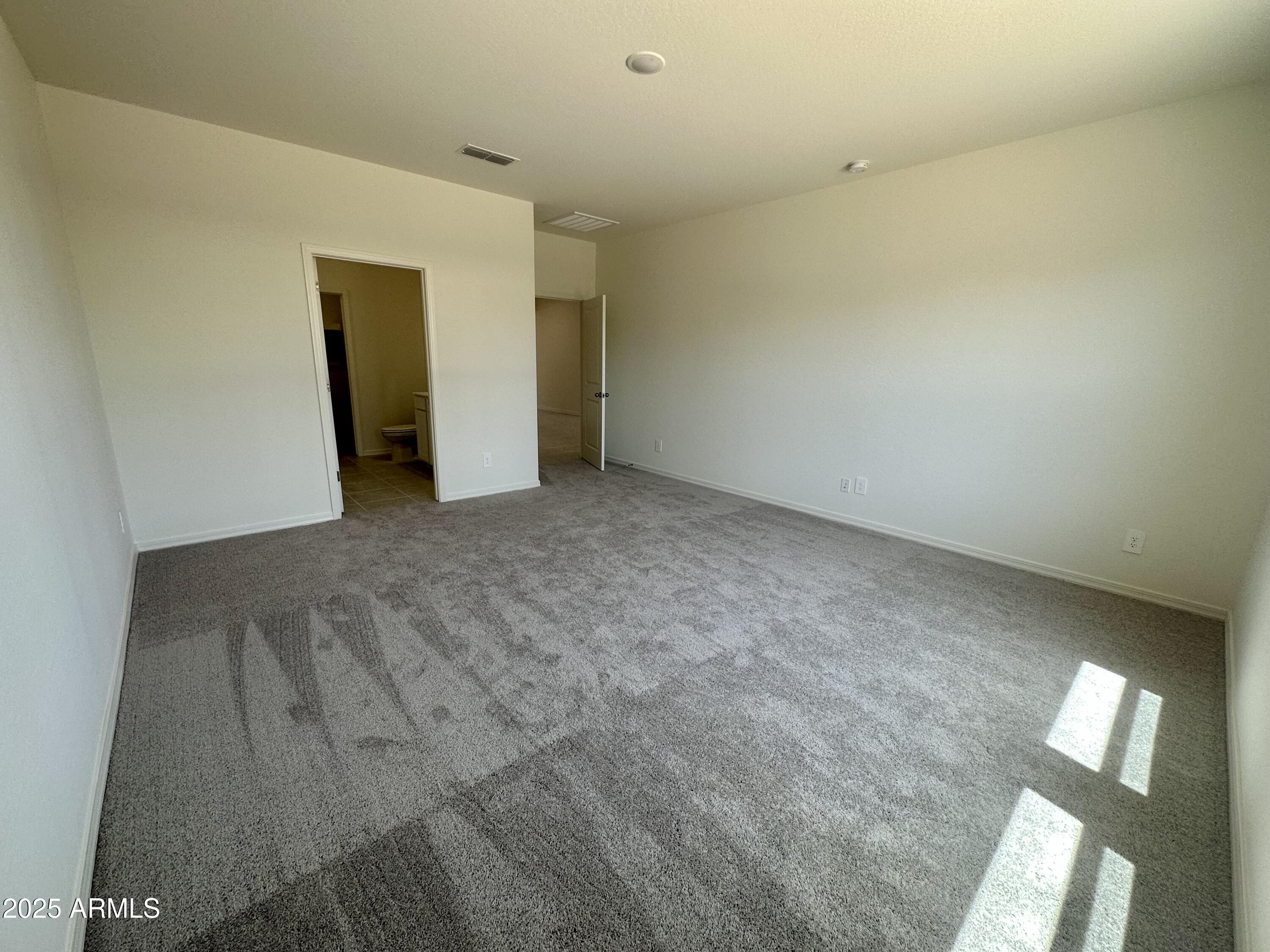 5642 East Iris Drive Florence, AZ 85132 - Photo 7 of 13 an empty room with closet and mirror