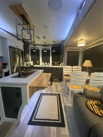 a kitchen with a sink and stainless steel appliances
