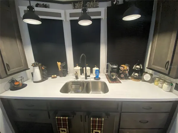 a kitchen with a refrigerator sink and stove