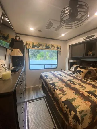 a bedroom with a bed and a television
