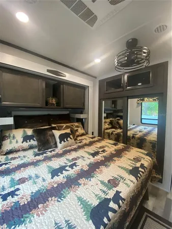 a bedroom with a bed and flat screen tv