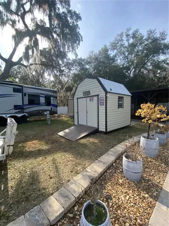a view of a backyard with a large tree