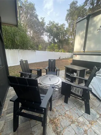 a living room with furniture a large window and a wooden floor