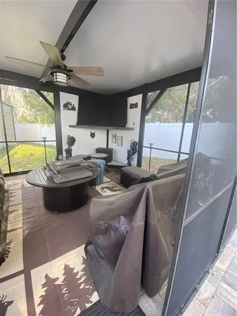 a backyard of a house with barbeque oven and outdoor seating