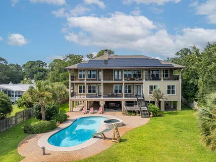 a view of a house with a swimming pool and sitting area