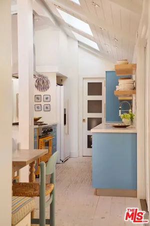 a view of a dining room with furniture and window