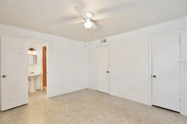 an empty room with fan and a ceiling fan