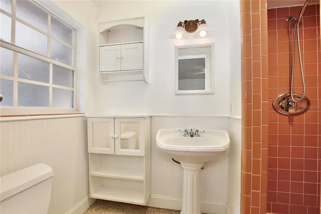 a bathroom with a sink toilet and shower