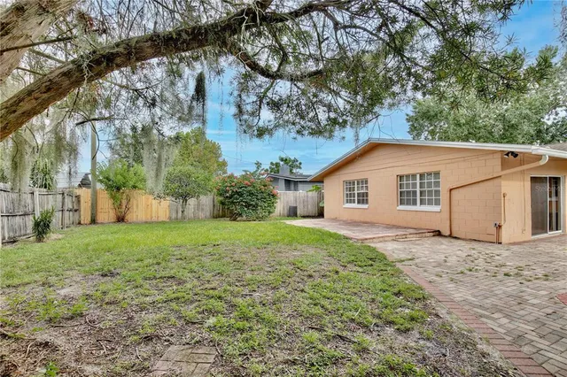 a view of a backyard with large trees