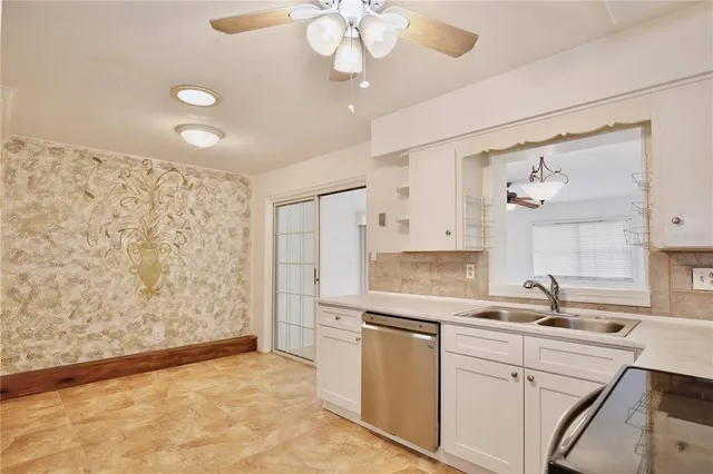 a kitchen with a sink cabinets and refrigerator