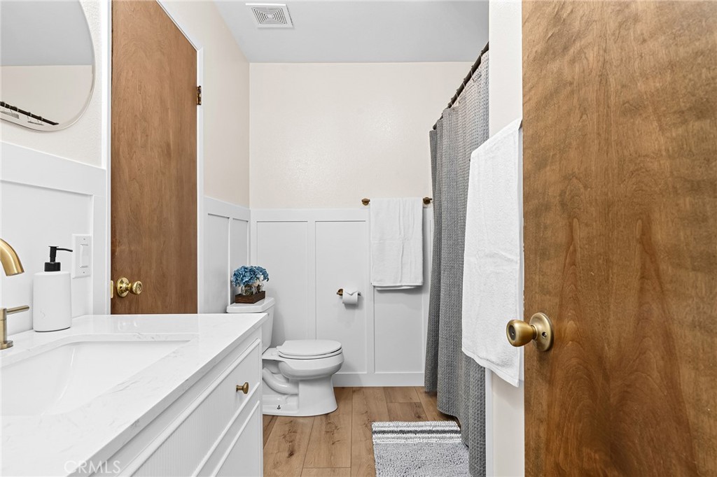 1261 Parque Drive Chico, CA 95926 - Photo 20 of 45 a bathroom with a sink a toilet a mirror and shower