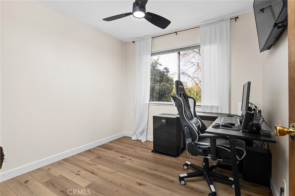 1261 Parque Drive Chico, CA 95926 - Photo 24 of 45 a view of workspace with wooden floor windows ceiling fan and windows