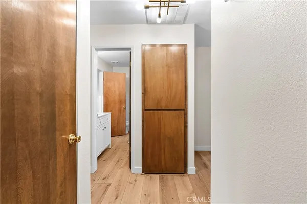 a view of a hallway with wooden floor