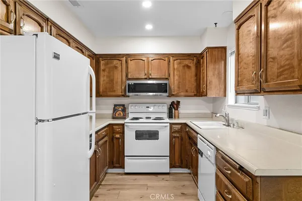 a kitchen with a refrigerator sink and stove