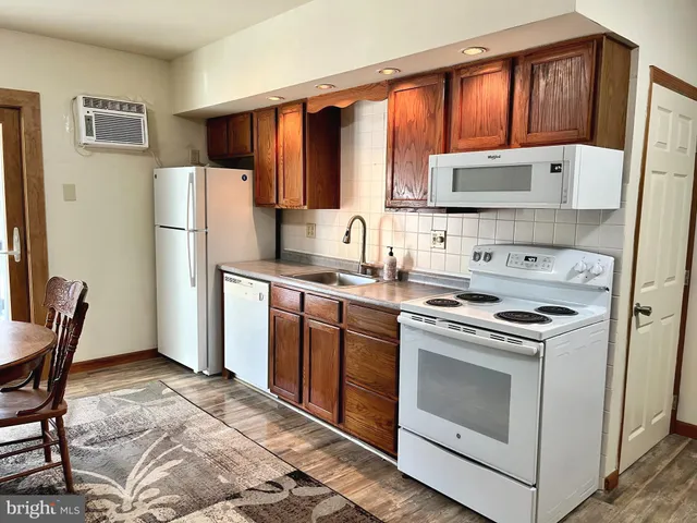 a view of a livingroom with furniture and a window