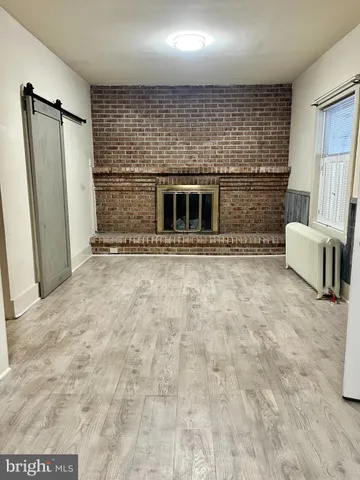 a view of an empty room with a fireplace