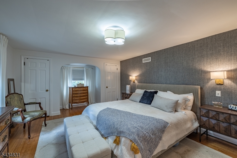 200 Wychwood Road Westfield, NJ 07090 - Photo 14 of 31 a bedroom with a bed and a chandelier