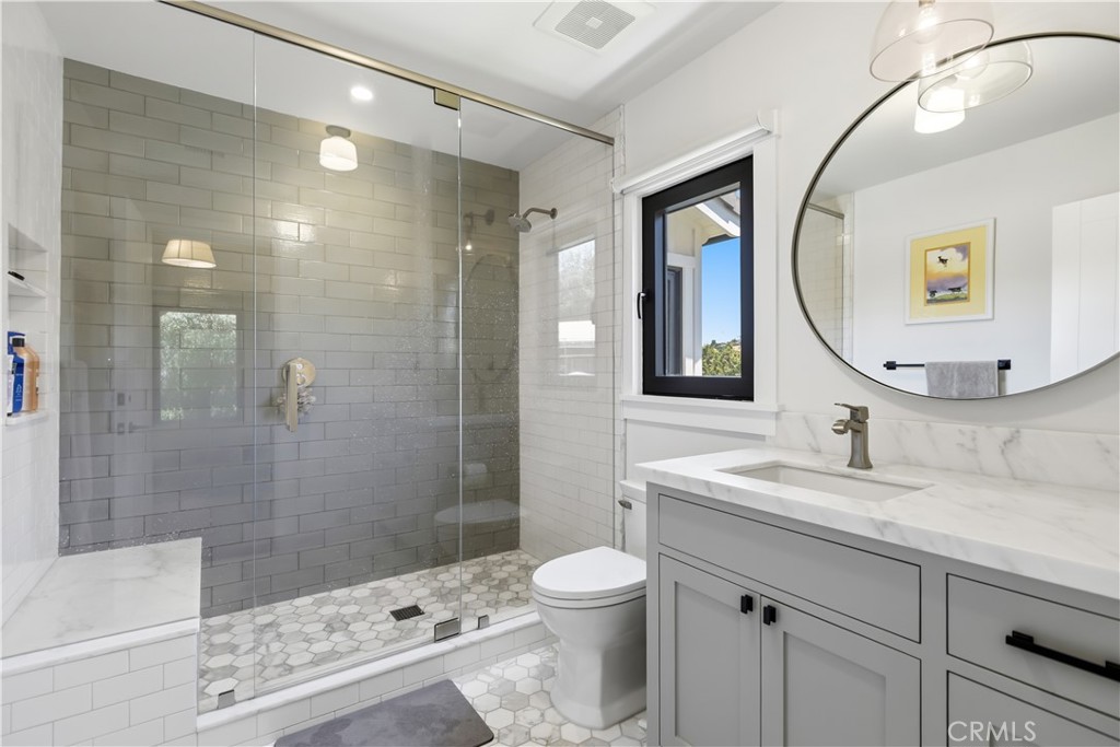 24884 Jim Bridger Road Hidden Hills, CA 91302 - Photo 19 of 31 a bathroom with a sink a toilet and shower