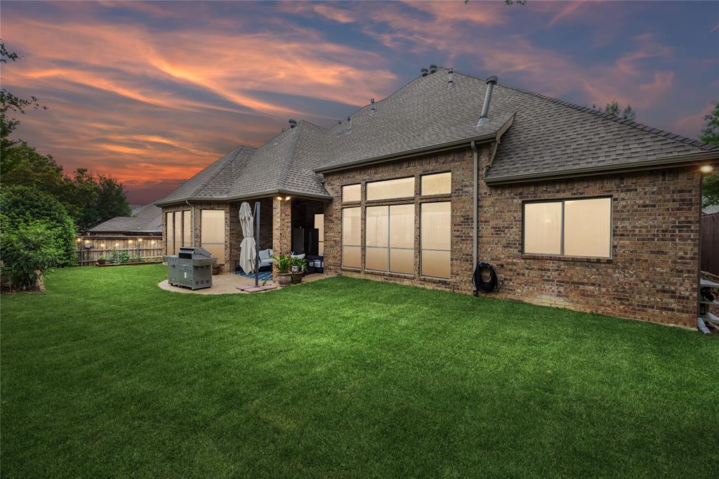1608 Tuscan Ridge Circle Southlake, TX 76092 - Photo 33 of 36 a front view of a house with a garden and yard