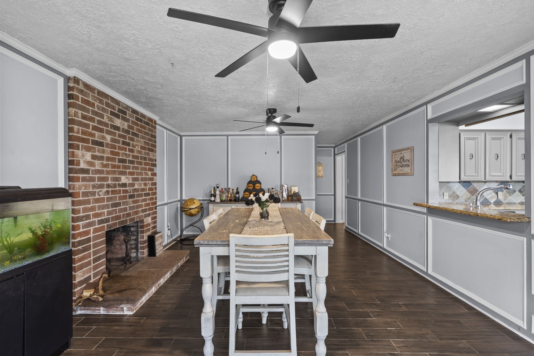 7009 Avenue R Santa Fe, TX 77510 - Photo 15 of 48 Beautiful dining room with exposed brick fireplace.