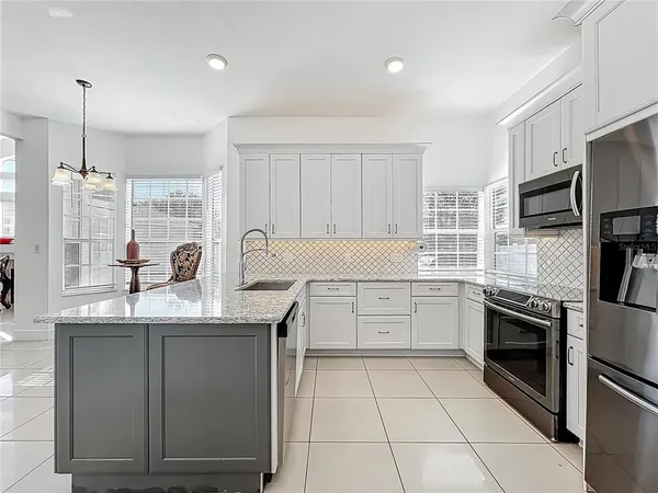 a kitchen with a sink appliances and cabinets