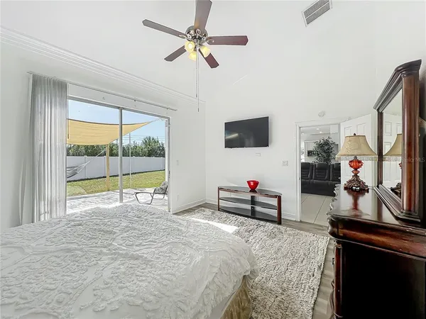 a bedroom with furniture and a flat screen tv