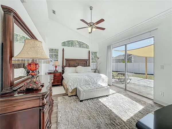 a bedroom with a bed and a large window