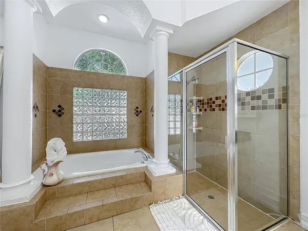a bathroom with a tub and shower