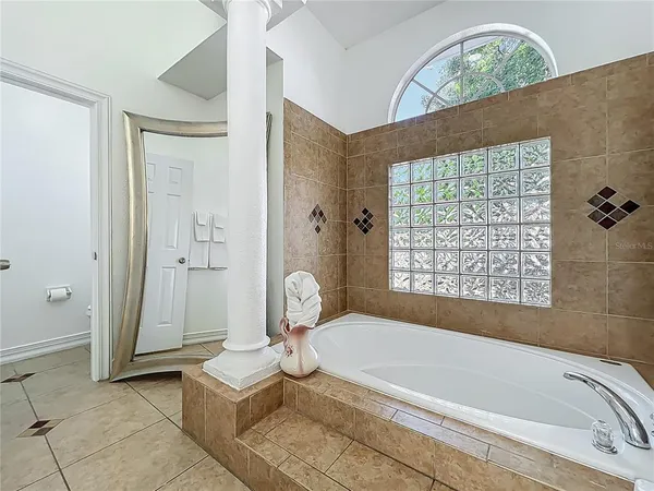 a bathroom with a tub a sink and a shower