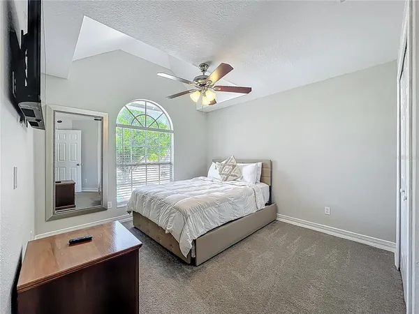 a bedroom with a bed and a window