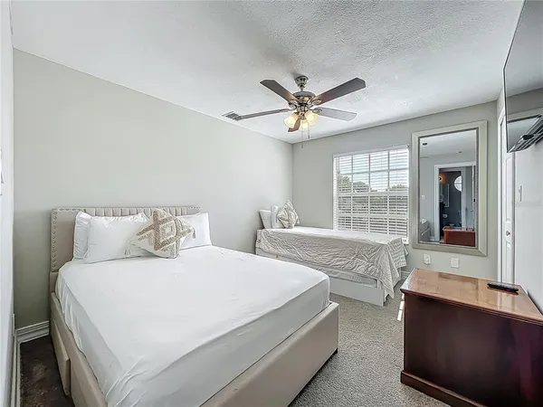 a spacious bedroom with a large bed and a window