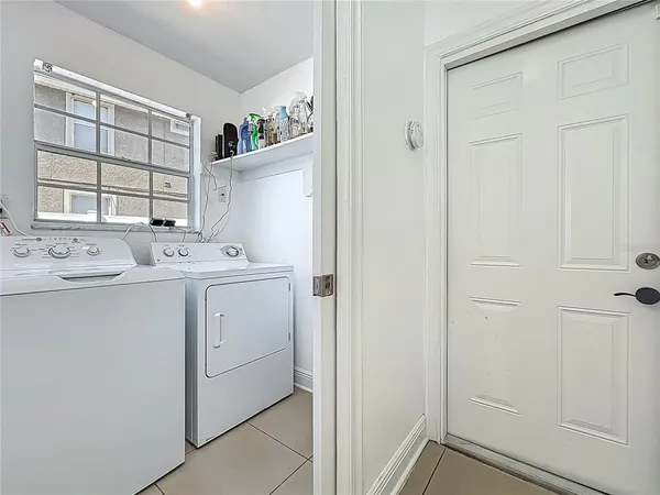 a utility room with cabinets washer and dryer