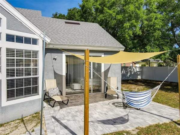 a backyard of a house with wooden floor and outdoor seating