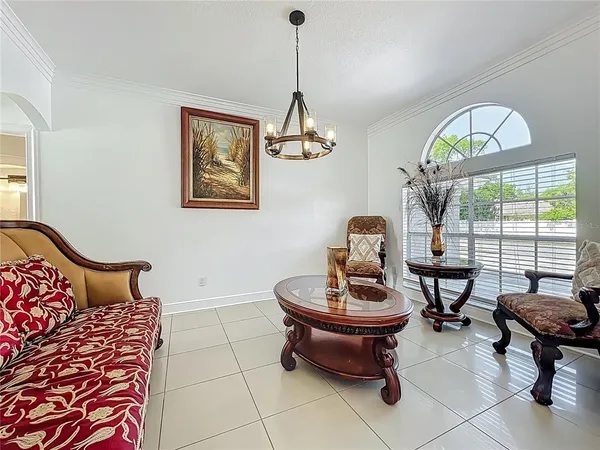 a living room with furniture a window and a chandelier