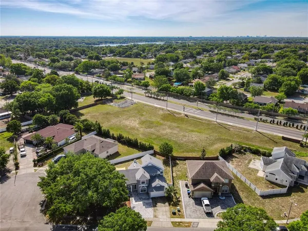 an aerial view of residential houses with outdoor space and swimming pool