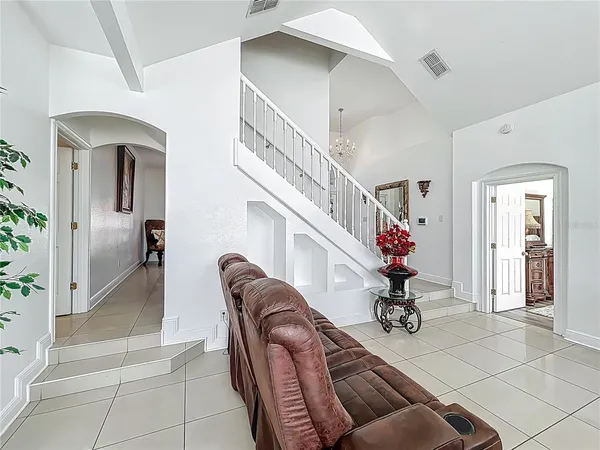 a living room with furniture and a potted plant