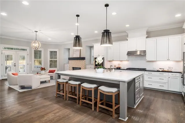 a large kitchen with stainless steel appliances lots of counter space wooden floor and stainless steel appliances