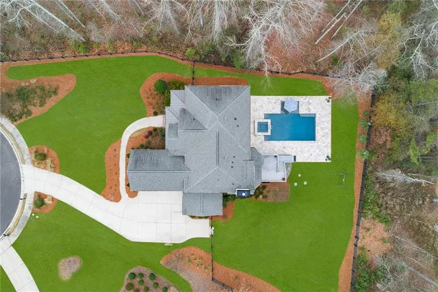 a dining room with furniture a chandelier and wooden floor